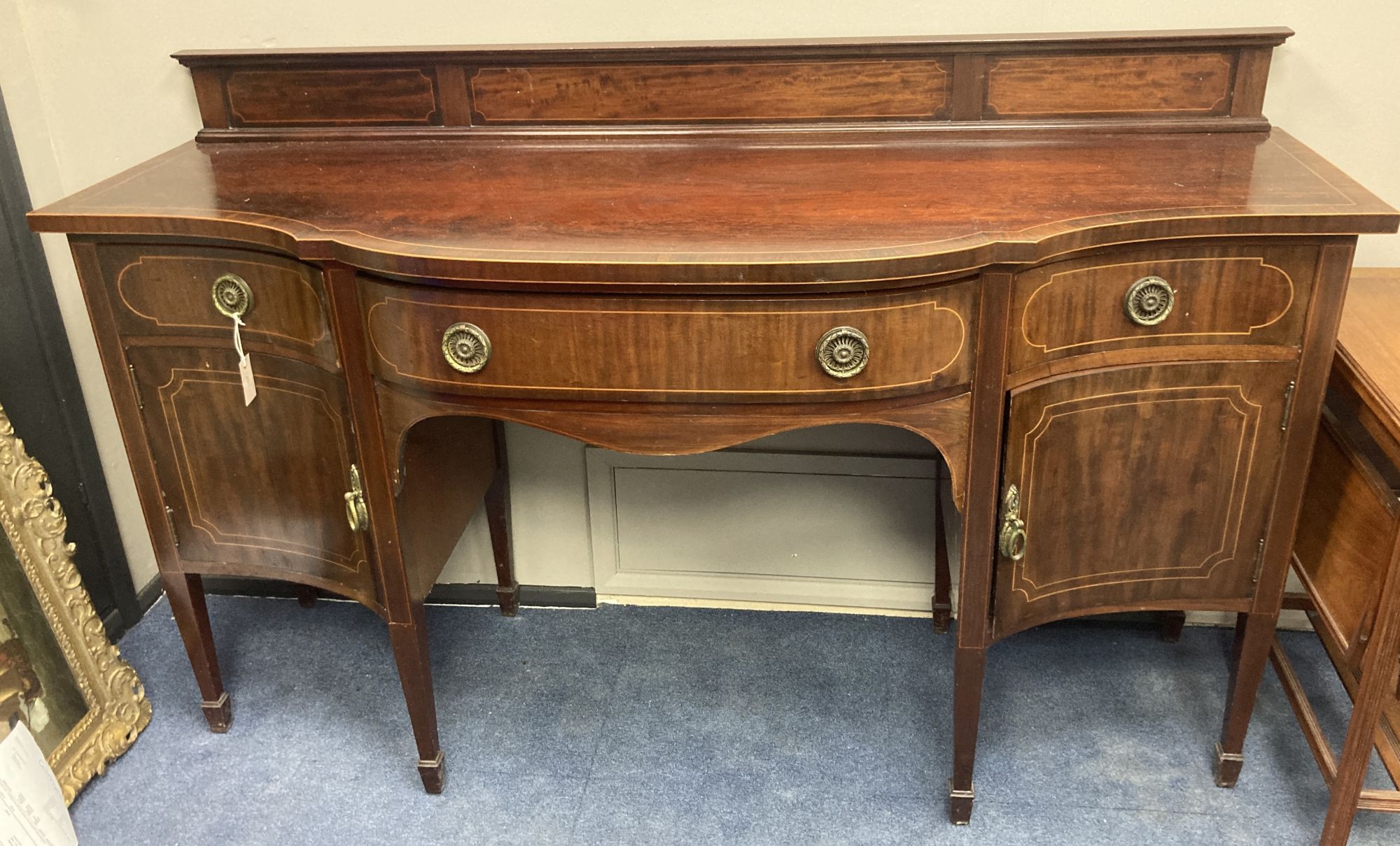An Edwardian inlaid mahogany serpentine fronted sideboard, length 184cm, depth 68cm, height 112cm
